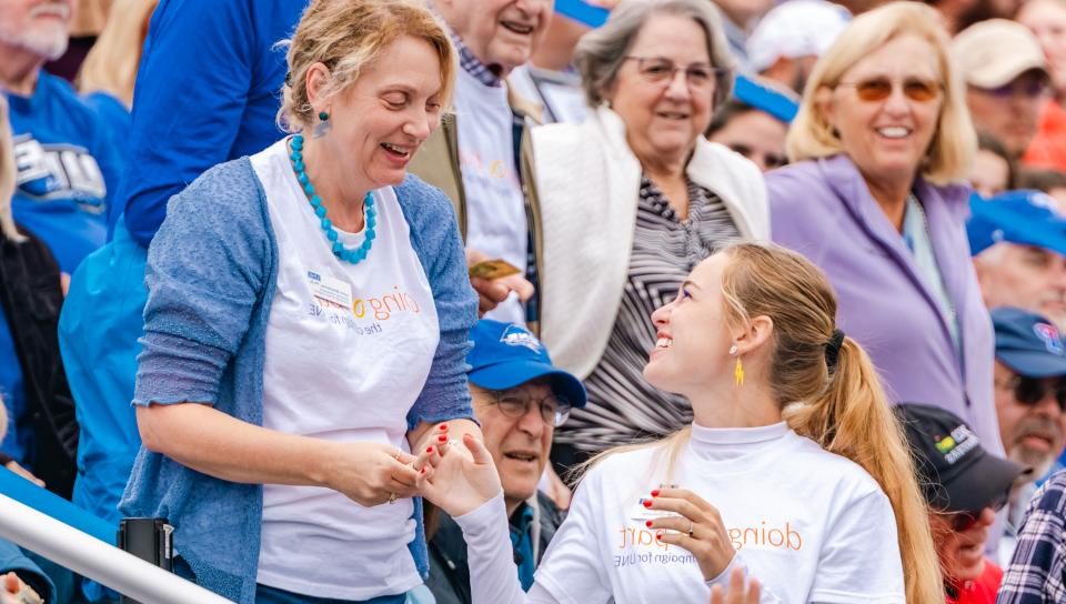 UNE First Lady Lynn Brandsma greets a student